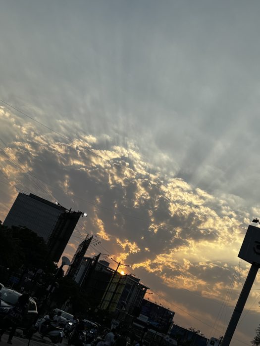 Sunburst over the city at dusk