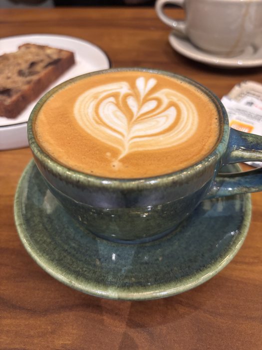 Latte art in a green ceramic cup