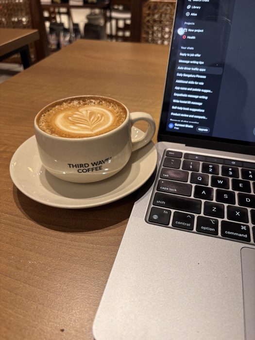 Coffee beside a laptop, mid-design